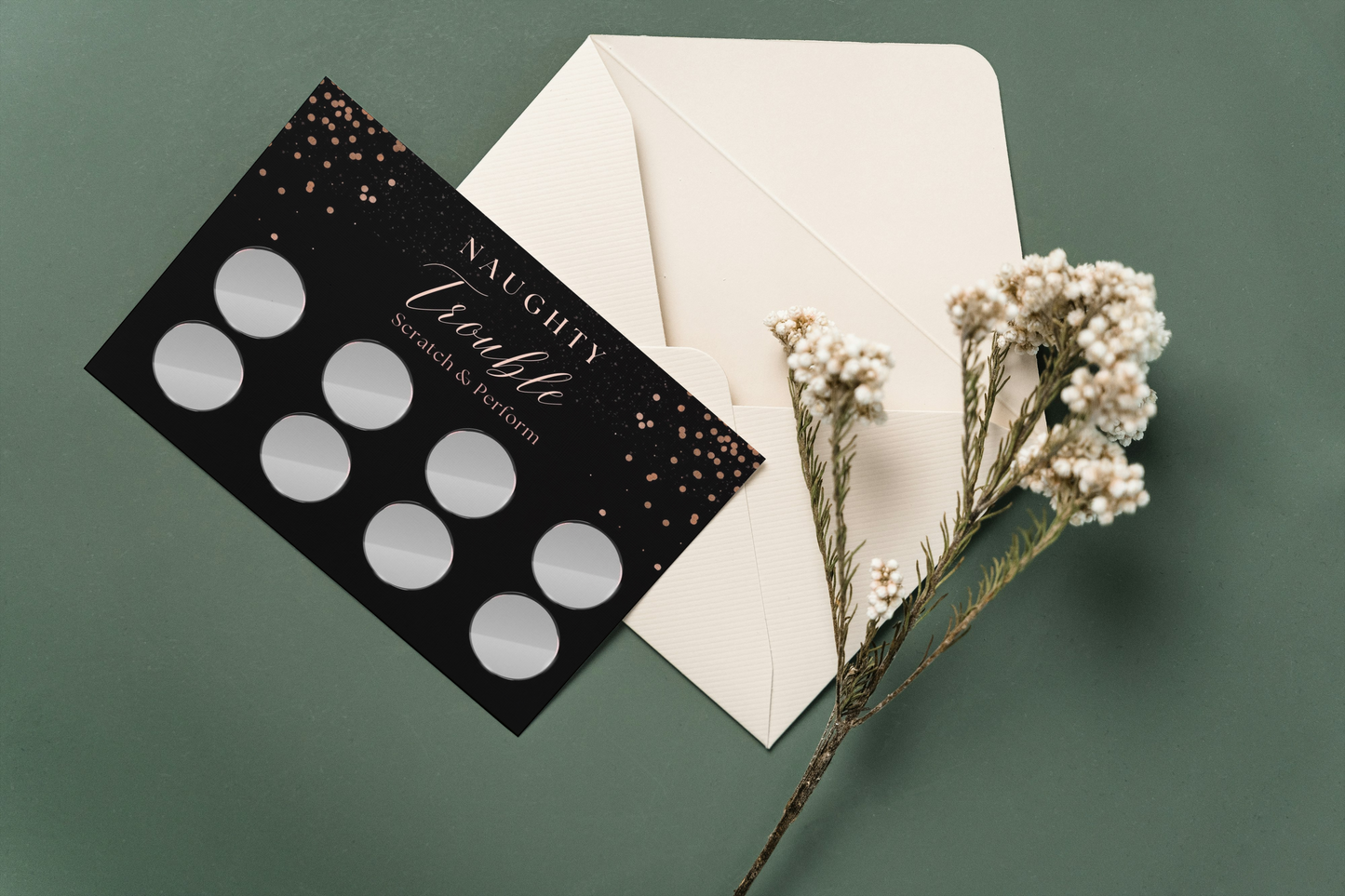 Beautiful flat lay of Naughty Trouble scratch cards with whipped cream, cuffs, and chocolates for a sexy couples game night.