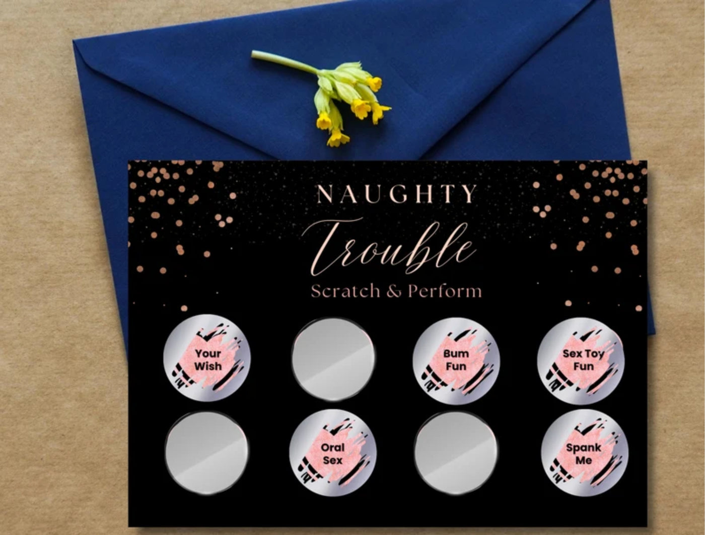 Man and woman smiling on the bed while reading a naughty dare from the Naughty Trouble adult card game.